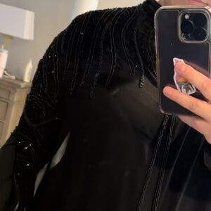Black abaya cape , very detailed and beautiful beaded . High neckline.